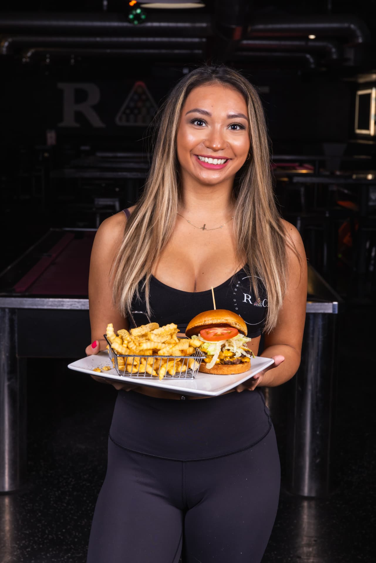 Rack server presenting a cheeseburger with crinkle-cut fries on the pool room floor